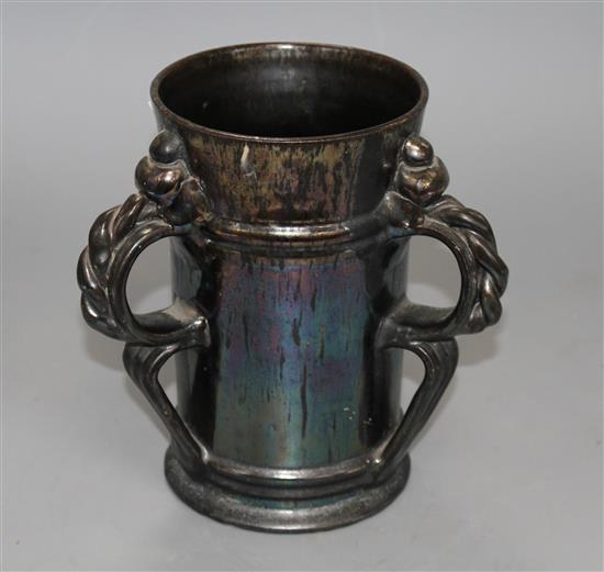 A Dickerware black lustre three handed tyg, early 20th century, indistinct impressed mark, height 18.5cm